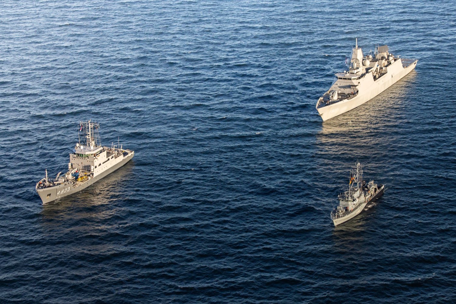 Aerial view of the survey vessel Zr.Ms. Luymes, a minehunter and the frigate Zr.Ms. Tromp holding station together on open sea