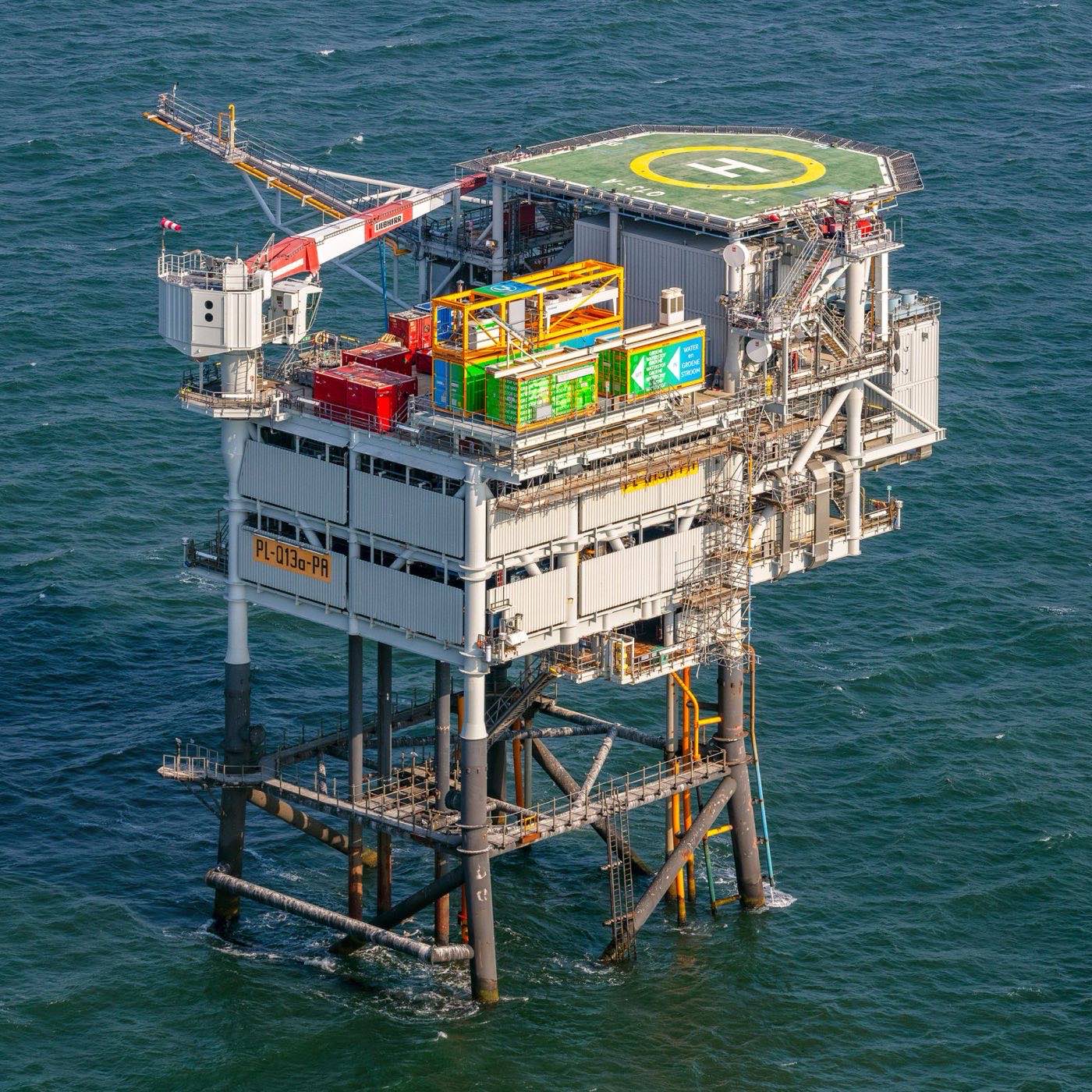 Aerial view of the Q13a-A platform in the Dutch North Sea, with the green containerised PosHYdon hydrogen plant visible on its topsides